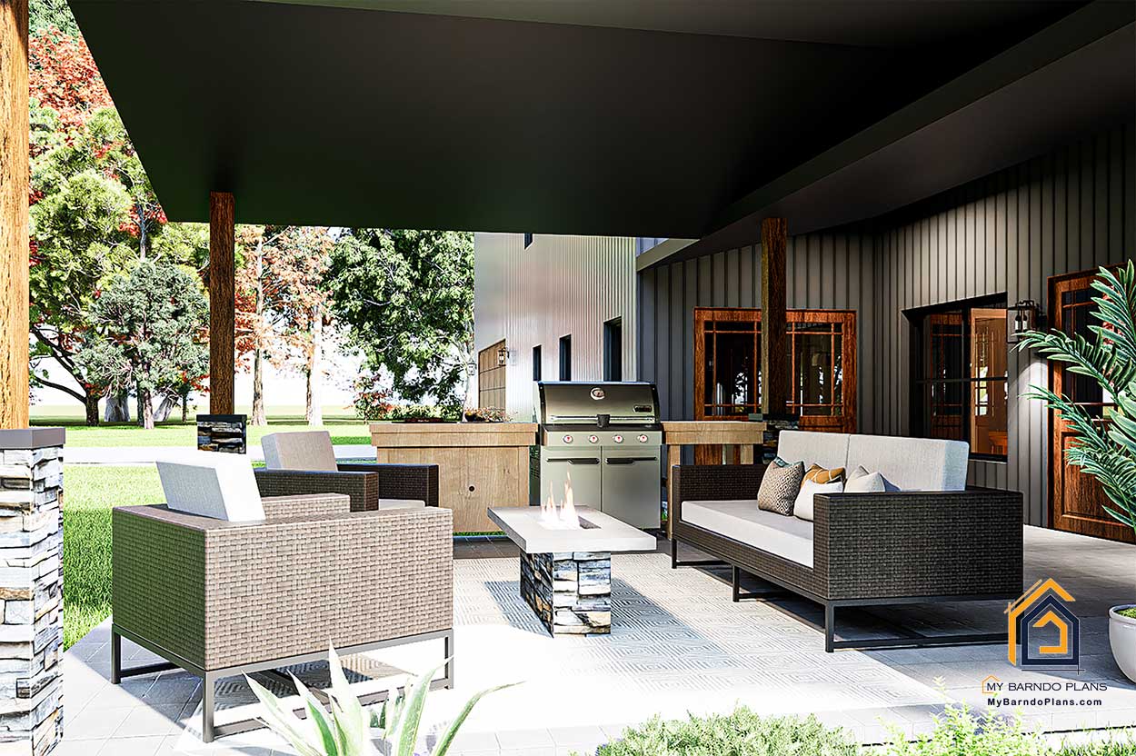 Outdoor living area of the Double D Ranch Barndominium with built-in grill, fire table, and modern patio furniture