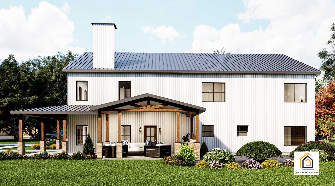 Back view of the 40x60 Barndominium called the 2200 featuring white siding, a black metal roof, and large covered patio area with outdoor seating.