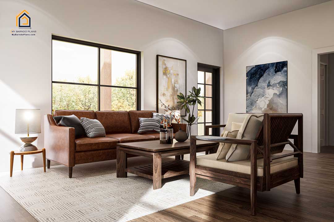 Comfortable living area in the Shire Barndominium featuring a leather sofa, modern artwork, wood furnishings, large windows, and abundant natural light.