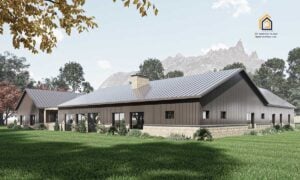 Back view of the Legacy Barndominium highlighting its long single-story layout, multiple windows, and stone wainscoting against a mountain backdrop.