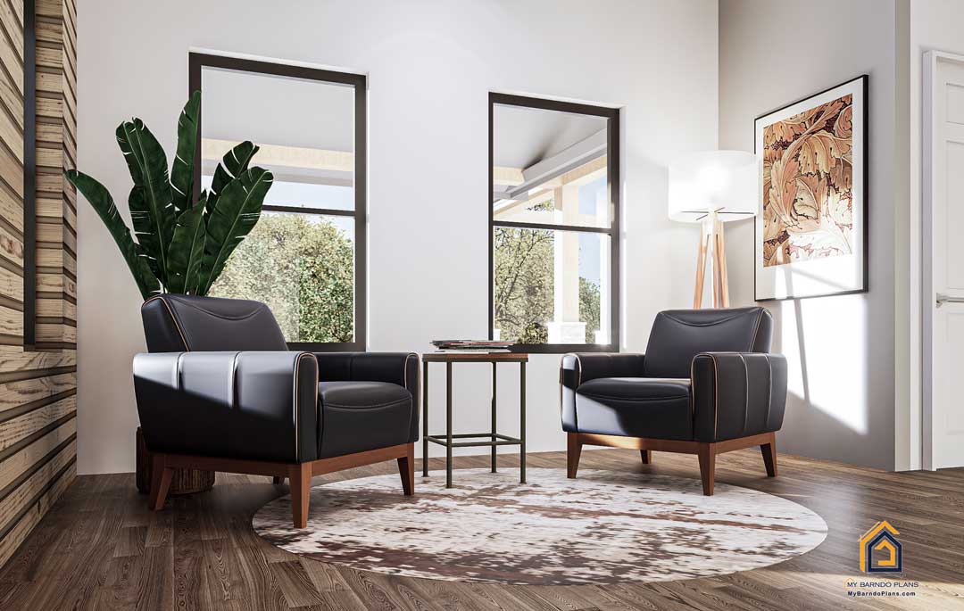 nviting sitting area in the master suite of the Summit Barndominium, with two contemporary leather chairs, stylish decor, and bright windows overlooking outdoor greenery.