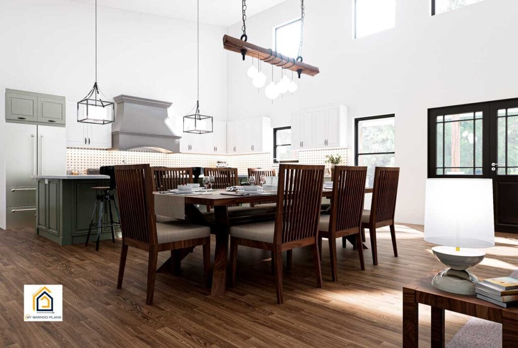Dining area inside The Arcadia barndominium with large windows, wooden table, and high ceilings.